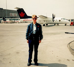 Dena Standing on aircraft runway in front of an Air Canada plane